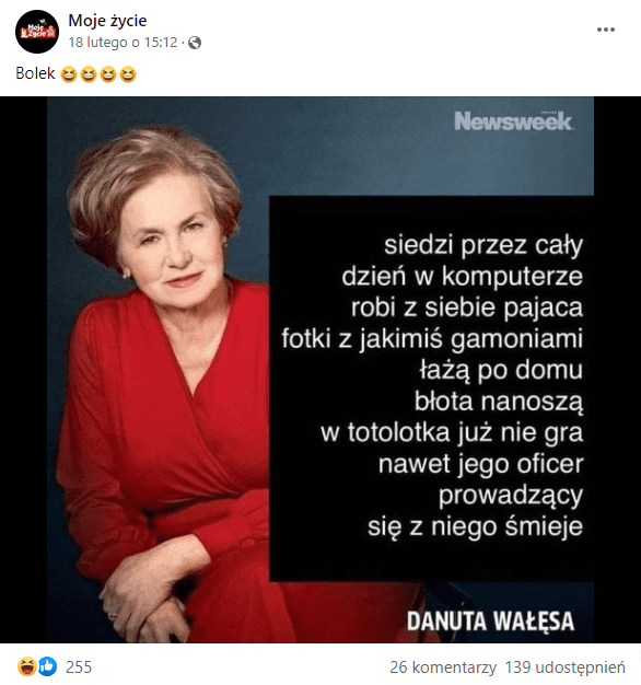 Zrzut ekranu posta na Facebooku. Post zawiera grafikę, na której widać Danutę Wałęsę. Ubrana w czerwoną sukienkę z długim rękawem siedzi i patrzy prosto w obiektyw. Ma krótkie blond włosy i makijaż.
