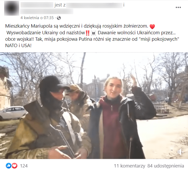 Zrzut ekranu wpisu na Facebooku, do którego dołączono nagranie. Na filmie znajduje się uśmiechnięta kobieta ubrana w czarną kurtkę i czerwoną bluzę w towarzystwie dwóch żołnierzy z bronią. Wpis uzyskał ponad 100 reakcji i ponad 80 udostępnień.