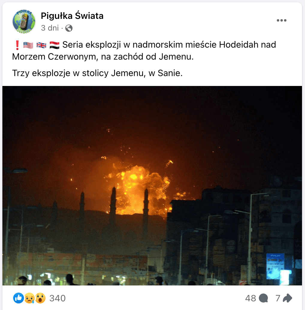 Zrzut ekranu posta na Facebooku. Na dołączone zdjęcie wykonano nocą. Znajdują się na nim budynki, minarety meczetu, znaki drogowe oraz latarnie uliczne. W tle uchwycono wybuch.