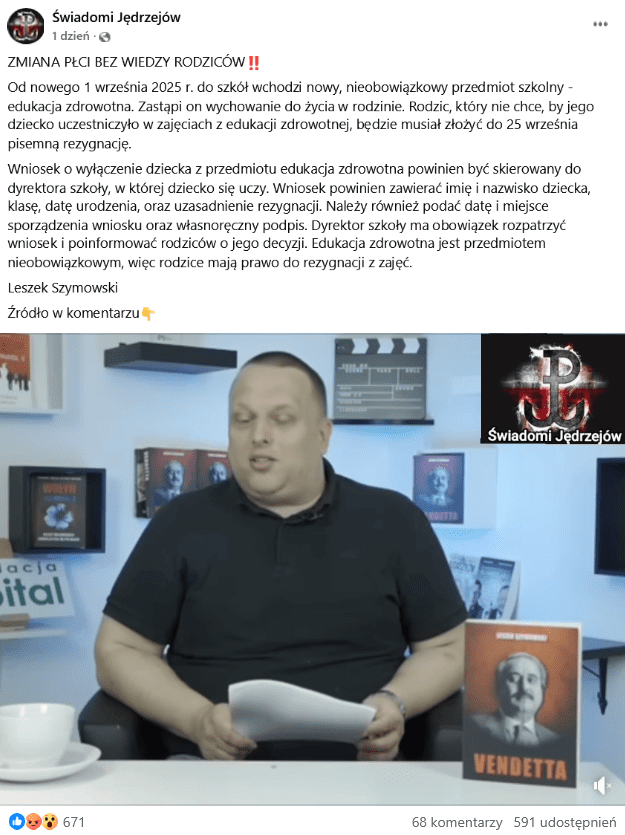 Zrzut ekranu z Facebooka. Na górze podpis i elementy interfejsu platformy, na dole klatka z filmu przedstawiająca mężczyznę siedzącego przy stole.